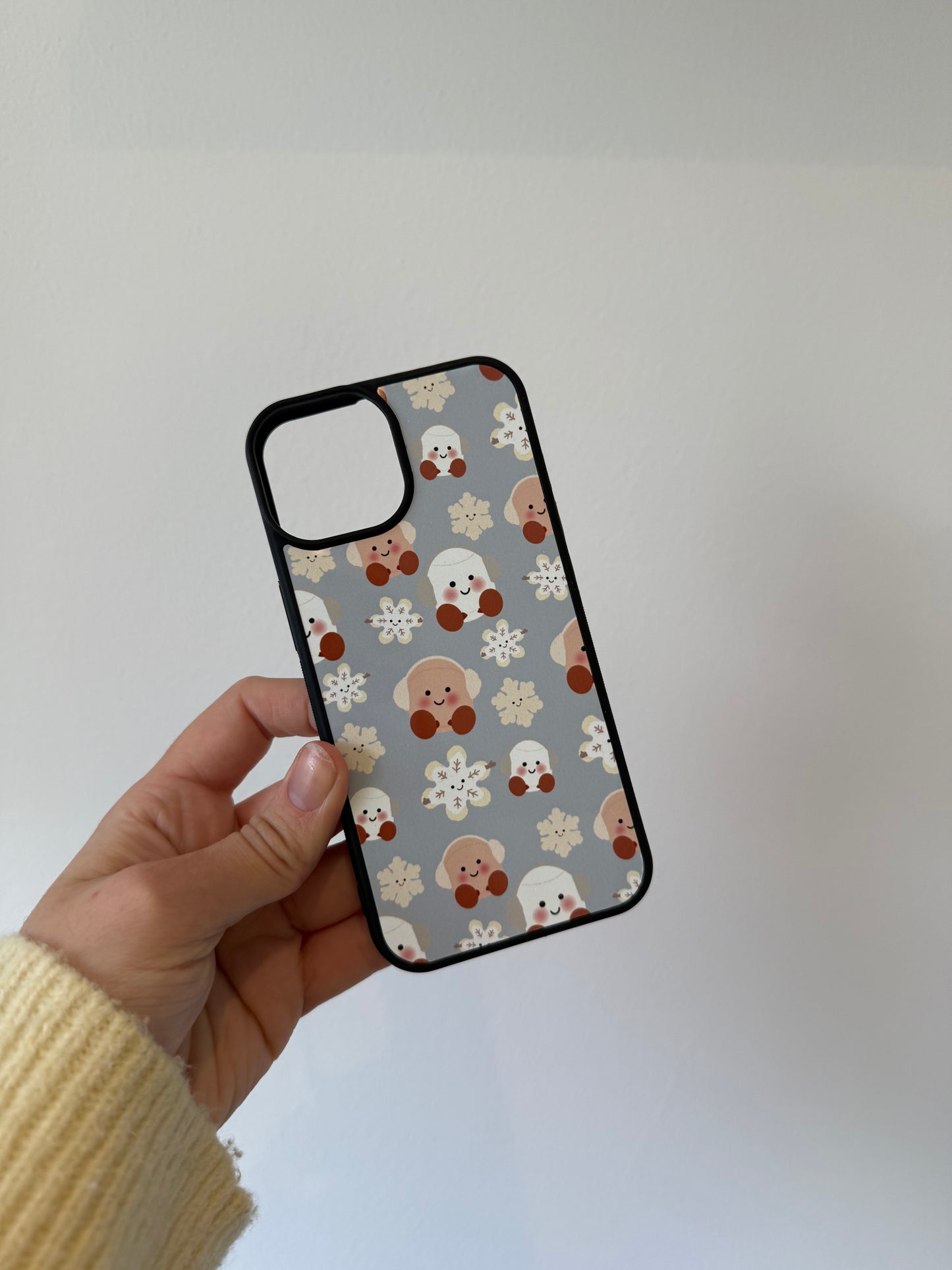 Marshmallow and snowflake phone case. Christmas. Blue background. Cuddly toys.
