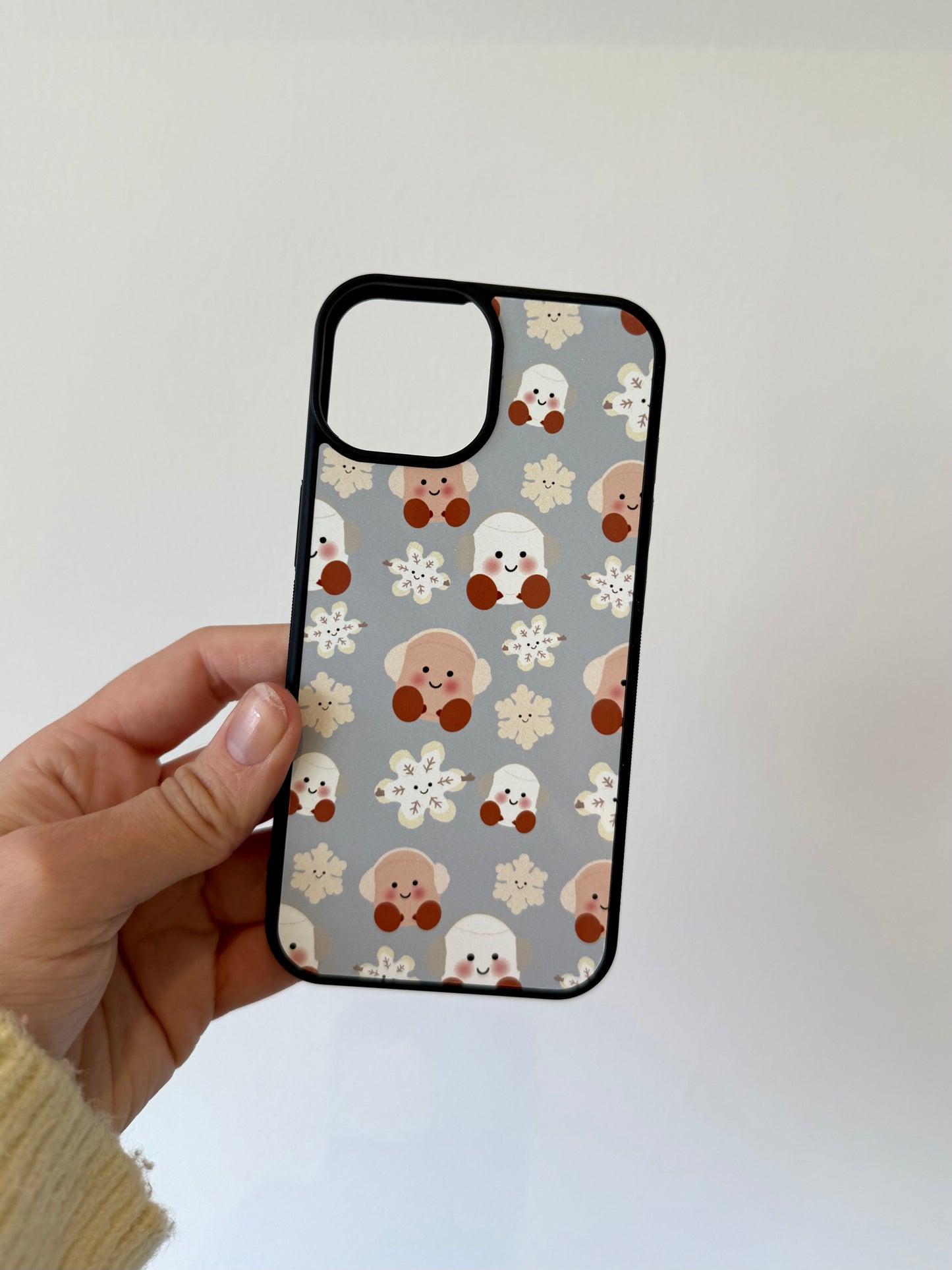 Marshmallow and snowflake phone case. Christmas. Blue background. Cuddly toys.