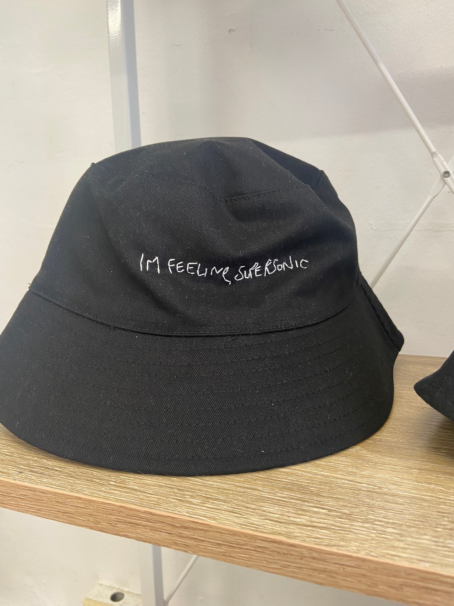 “Im feeling supersonic” bucket hat. Hand embroidered, black bucket hat.