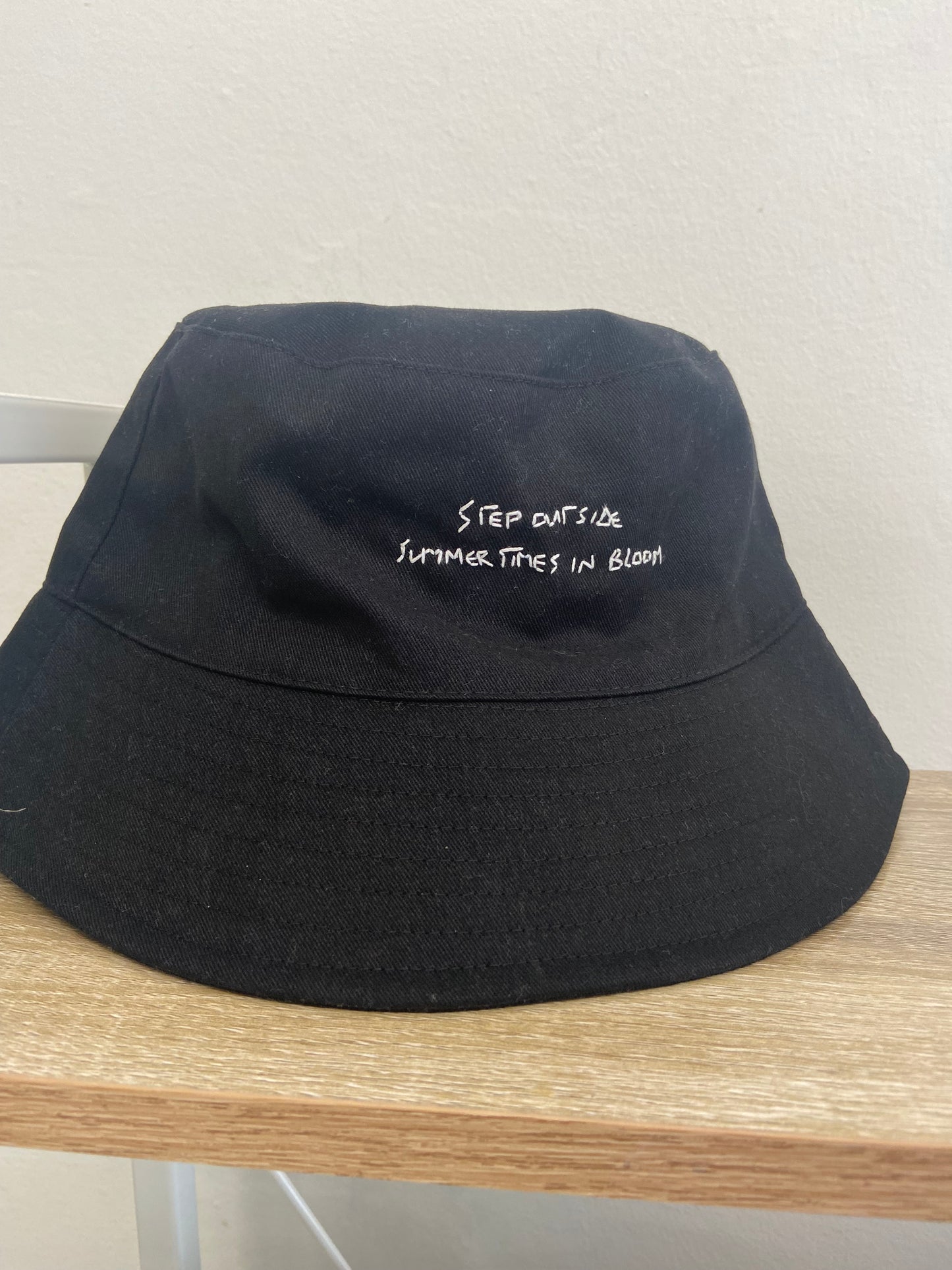 “Step outside summertimes in bloom” bucket hat. Hand embroidered, black bucket hat.